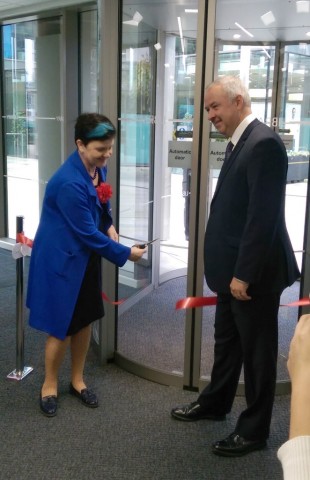 Baroness Neville Rolfe cuts the ribbon, watched by Councillor Ben Adams