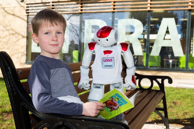 Child with NEO - the robot who welcomed visitors to the new library.
