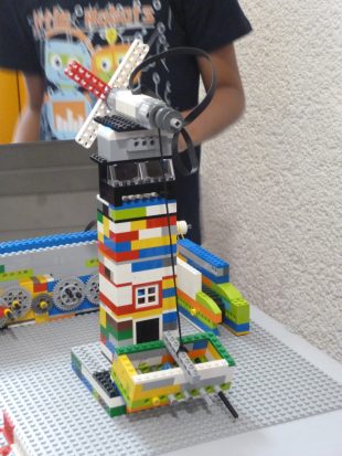 Participant in the Junior LEGO league with their creation. Photo credit: XXX