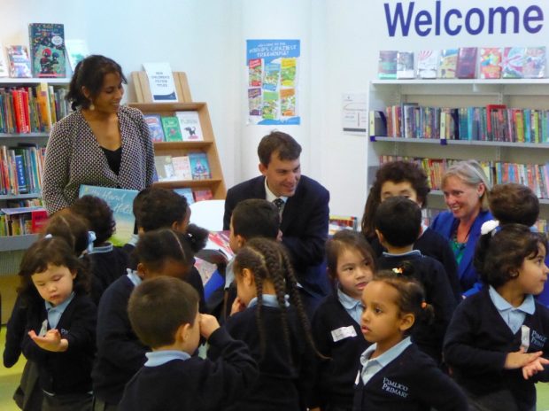 John Glen surrounded by children in Pimlico library. Also just visible are (on the right) author Smriti Prasadam Halls, and on the left, Cllr Jacqui Wilkinson, deputy Cabinet Member for environment and community services, at Westminster Council. 